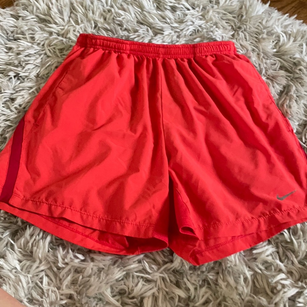 Orange Nike running shorts
